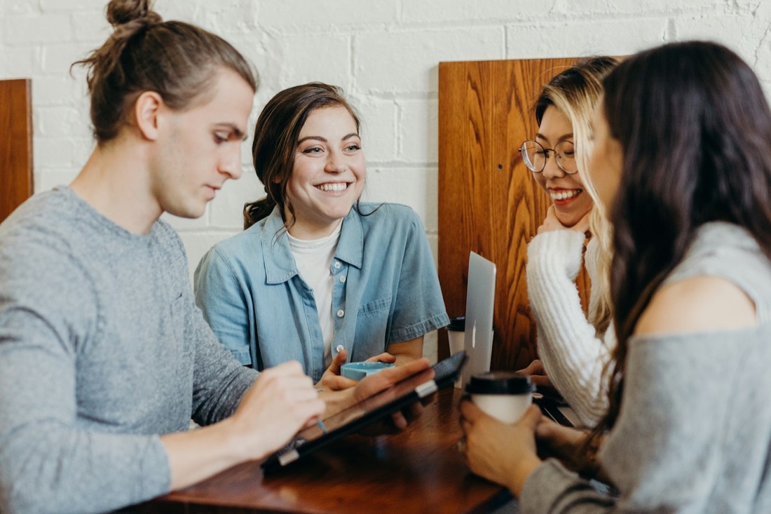 Colleagues collaborating and smiling around a table